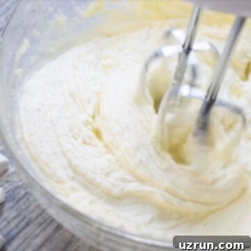 Easy Two-Ingredient White Chocolate Buttercream 7 Fluffy white icing in glass bowl.