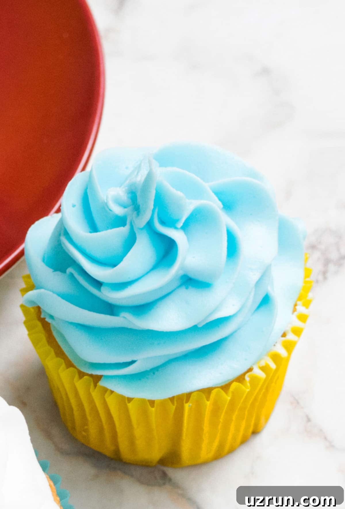 Easy Two-Ingredient White Chocolate Buttercream 9 Closeup Shot of 2 Ingredient Frosting That's Been Tinted Blue.