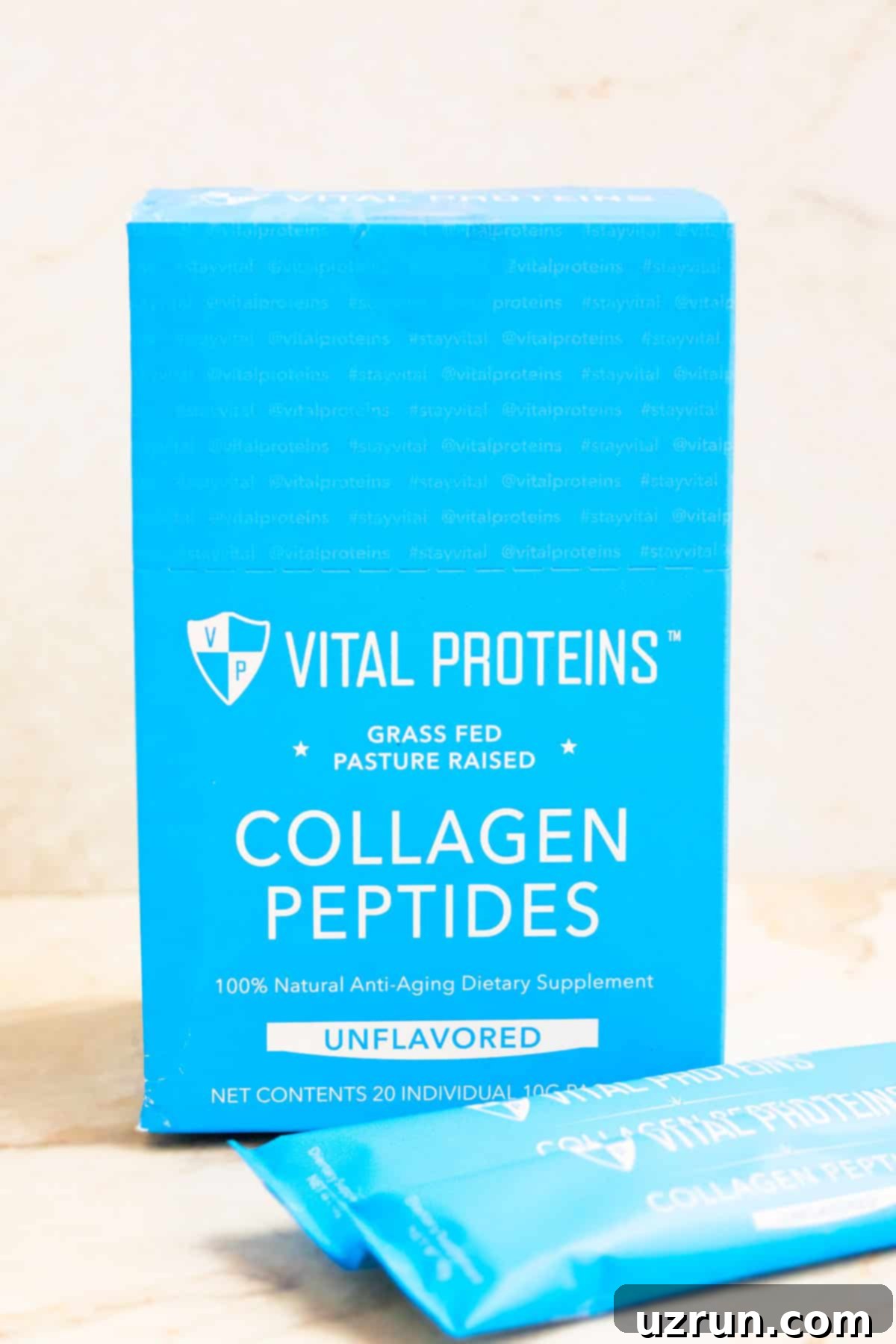Eggless Chocolate Chip Cookie Dough Bars 6 Blue Box of Vital Proteins Collagen Peptides Packets on White Marble Background.