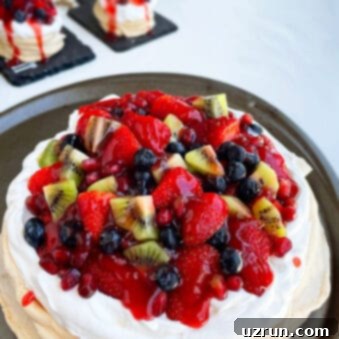 Whip Up a Dreamy Pavlova 8 Easy Homemade Pavlova Topped With Jam and Fresh Fruits on Metal Dish.