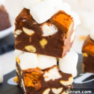 No-Bake Rocky Road Fudge 14 Stack of Rocky Road Fudge Slices on Black Dish With Off White Background.