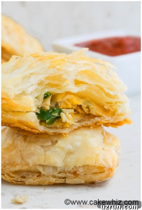Close-up of baked jalapeno chicken puffs with a golden crust, showing the slightly visible filling.