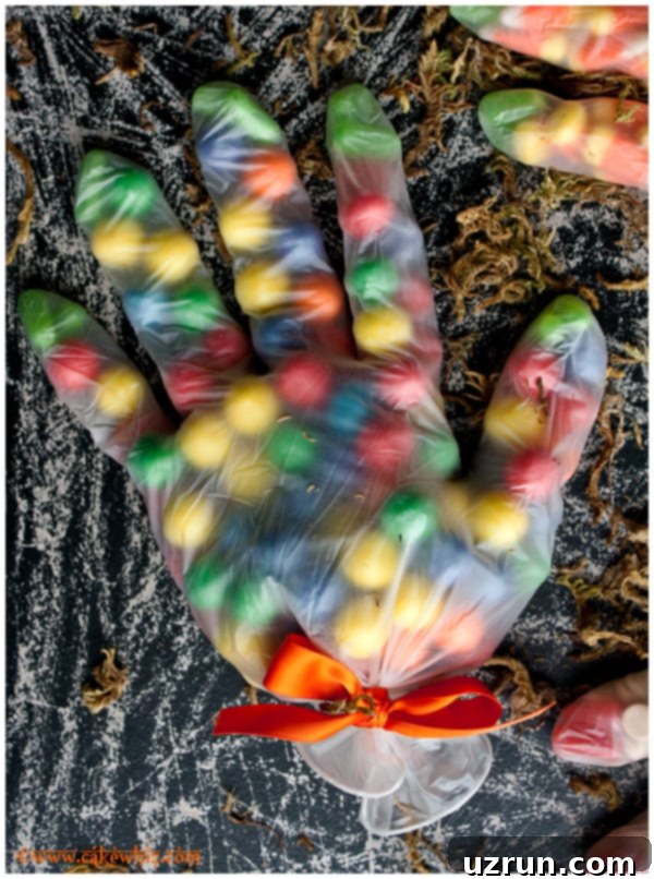 Easy Halloween Treat Bags With Candies in Gloves on Rustic Black Background